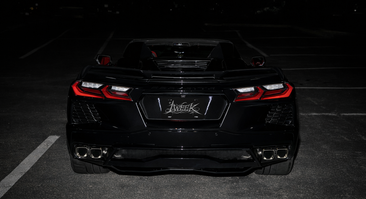 1WEEK Black car with a visible brand logo on a dark background